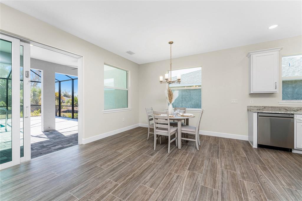 399 Sunset Road Rotonda West, FL 33947 - Photo 14 of 57 a view of a dining room with furniture window and wooden floor