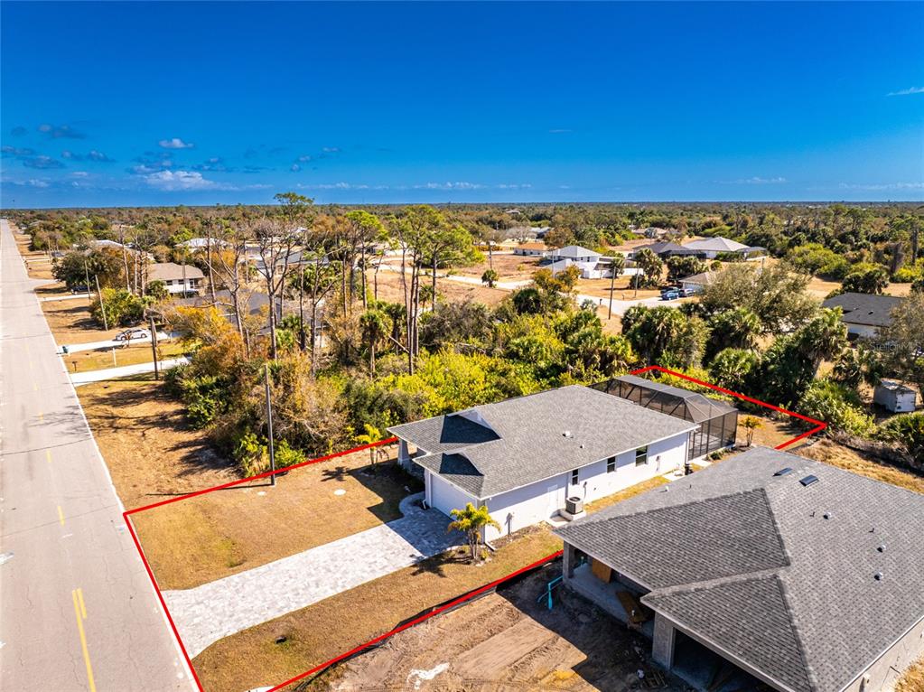 399 Sunset Road Rotonda West, FL 33947 - Photo 2 of 57 an aerial view of residential houses with outdoor space