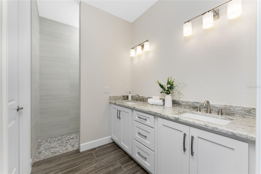 399 Sunset Road Rotonda West, FL 33947 - Photo 24 of 57 a bathroom with a granite countertop sink and a mirror