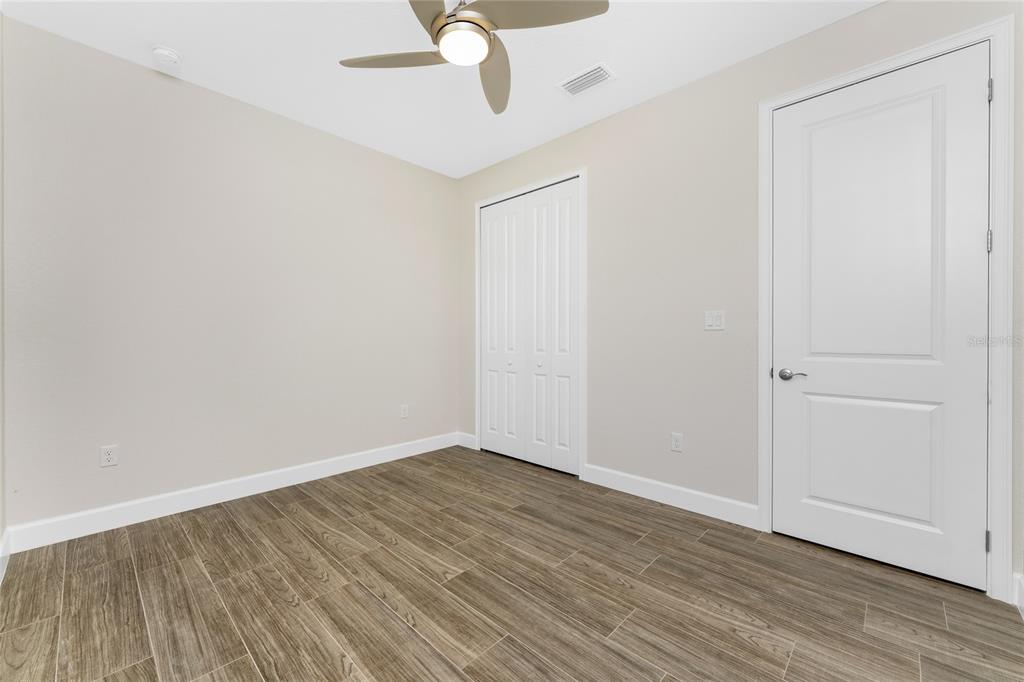 399 Sunset Road Rotonda West, FL 33947 - Photo 28 of 57 a view of an empty room with wooden floor
