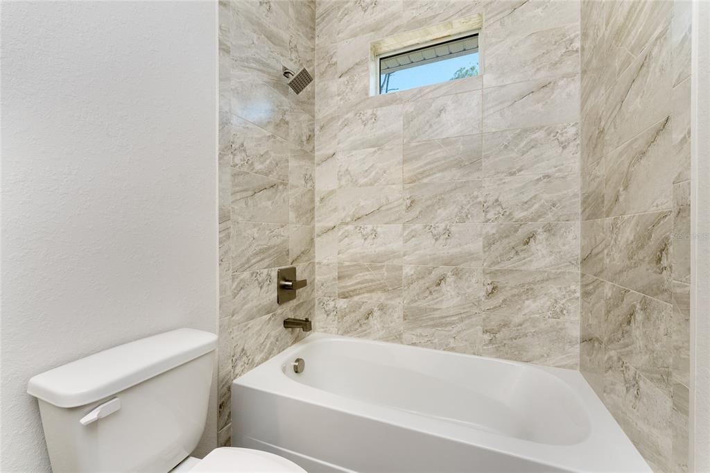 399 Sunset Road Rotonda West, FL 33947 - Photo 31 of 57 a bathroom with a toilet and a bathtub