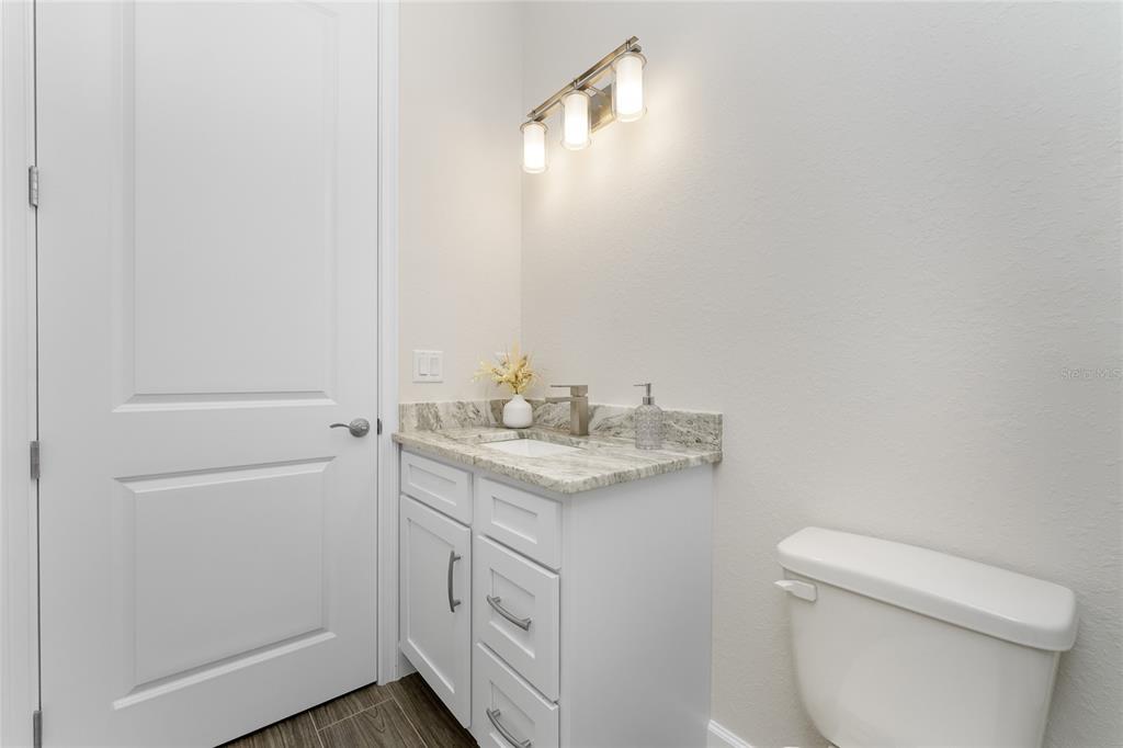 399 Sunset Road Rotonda West, FL 33947 - Photo 32 of 57 a bathroom with a sink toilet and vanity