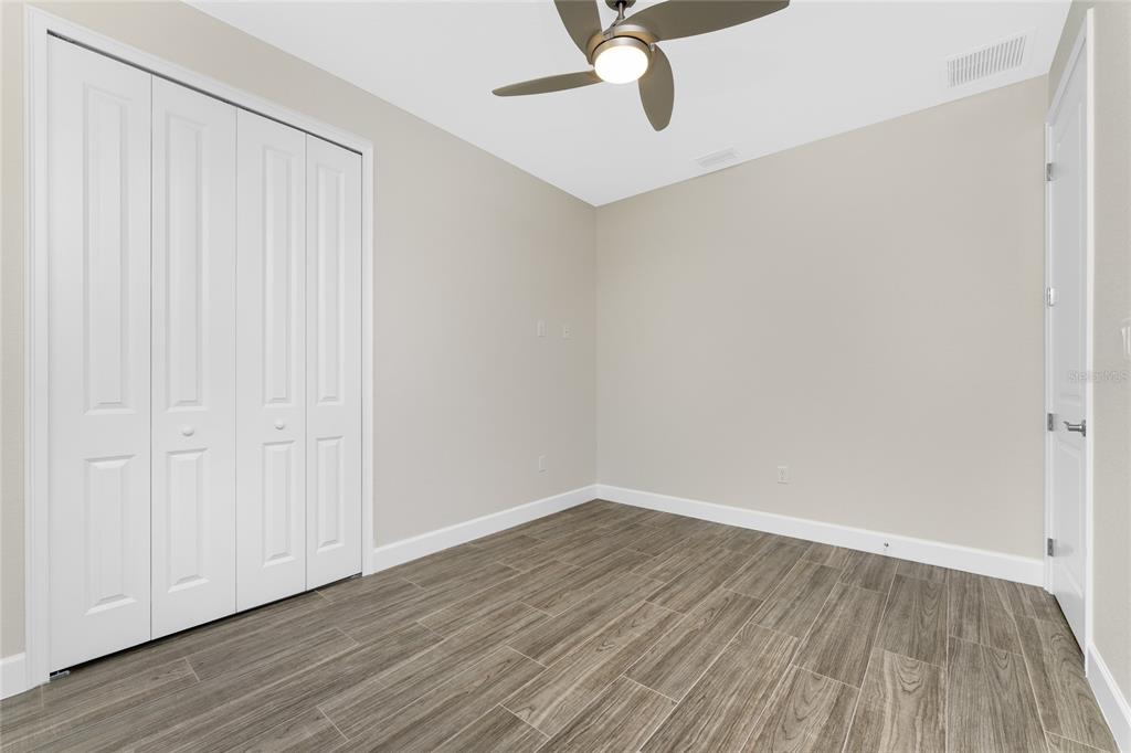 399 Sunset Road Rotonda West, FL 33947 - Photo 35 of 57 a view of a room with wooden floor closet and windows