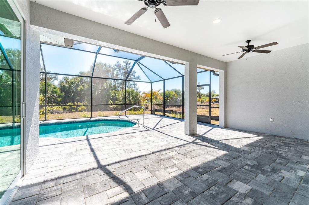 399 Sunset Road Rotonda West, FL 33947 - Photo 40 of 57 a view of an empty room and a window with a ceiling fan