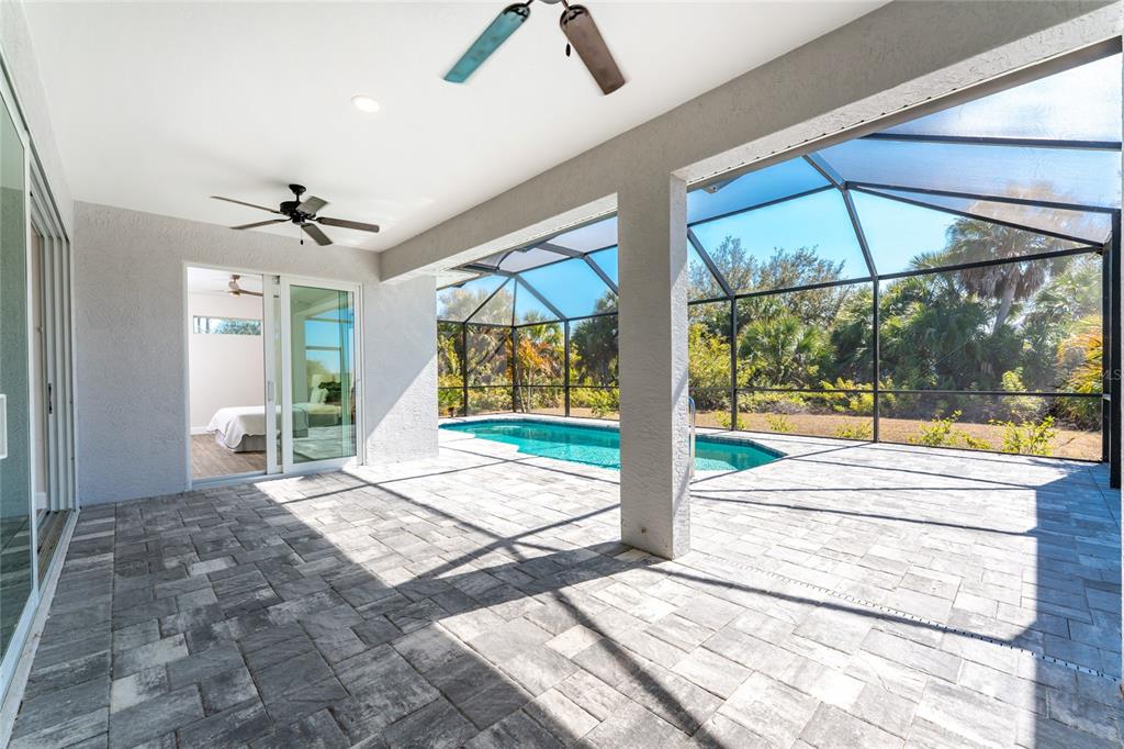 399 Sunset Road Rotonda West, FL 33947 - Photo 41 of 57 a view of an entryway with a floor to ceiling window and a ceiling fan
