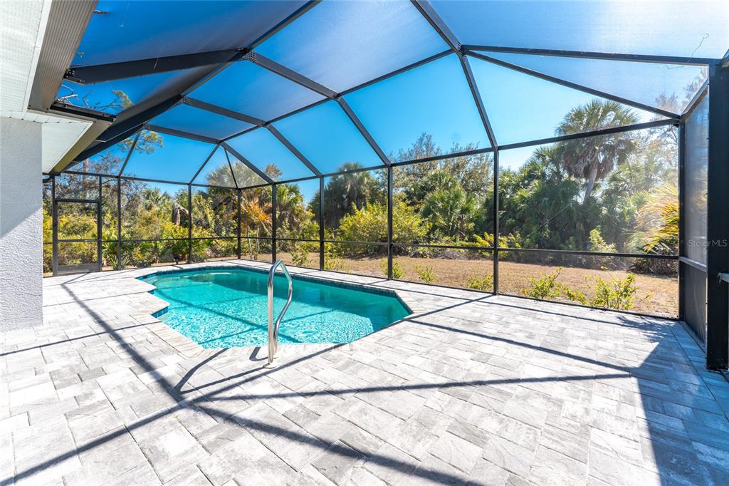 399 Sunset Road Rotonda West, FL 33947 - Photo 42 of 57 a view of a backyard with sitting area