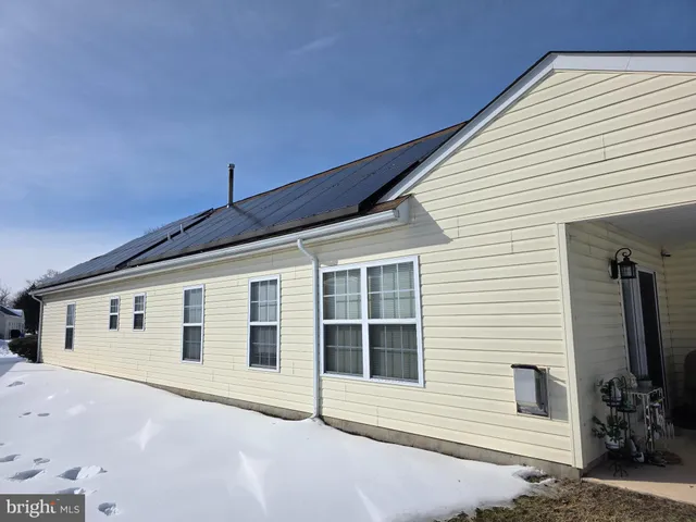 a front view of a house with a large window
