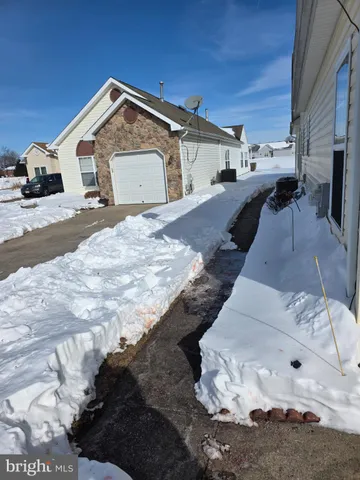 a view of a house with a snow in the yard