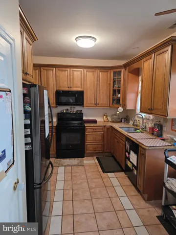 a kitchen with stainless steel appliances granite countertop a refrigerator stove and sink