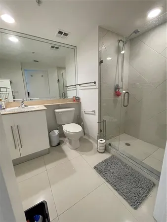a bathroom with a toilet sink and shower