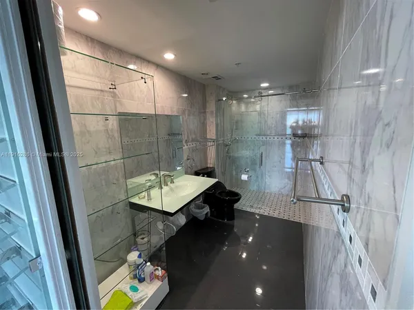 a bathroom with a sink mirror toilet and shower