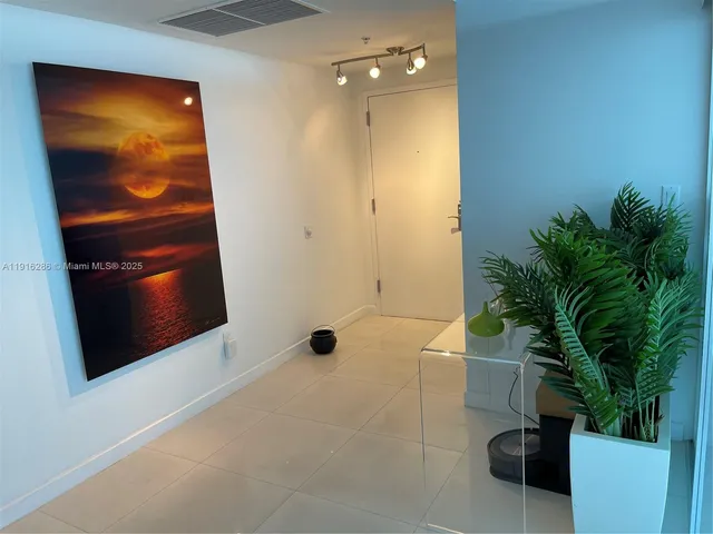 a bathroom with a shower and a plant
