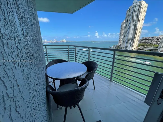 a view of a balcony with table and chairs