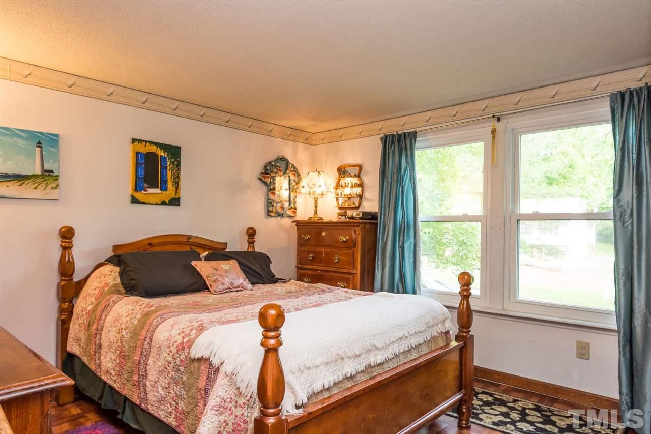 7140 Shellburne Drive Raleigh, NC 27612 - Photo 11 of 22 a bedroom with a bed and a window