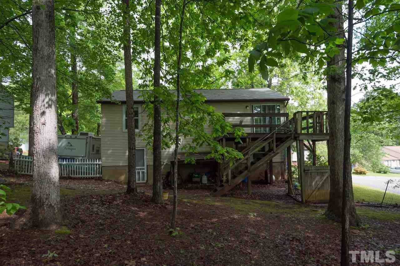 7140 Shellburne Drive Raleigh, NC 27612 - Photo 22 of 22 a view of a wooden house with a yard
