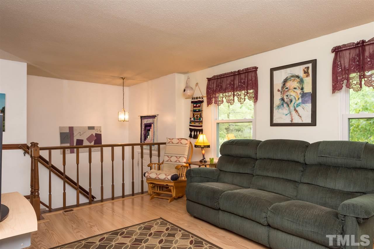 7140 Shellburne Drive Raleigh, NC 27612 - Photo 4 of 22 a living room with furniture and a window with wooden floor