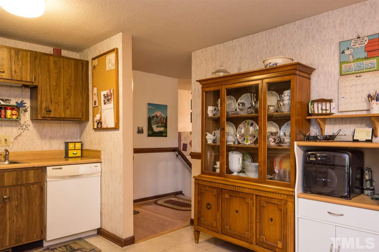 7140 Shellburne Drive Raleigh, NC 27612 - Photo 8 of 22 a kitchen with a refrigerator and cabinets