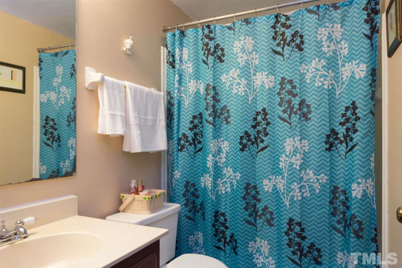 7140 Shellburne Drive Raleigh, NC 27612 - Photo 9 of 22 a bathroom with a sink and mirror