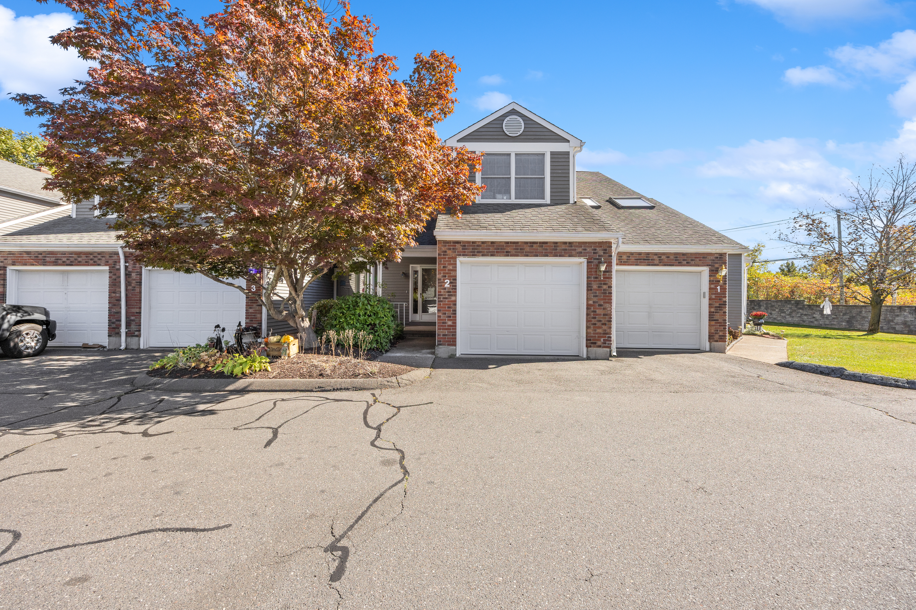 1325 Farmington Avenue, Unit 2 Bristol, CT 06010 - Photo 1 of 1 a front view of a house with a yard and garage