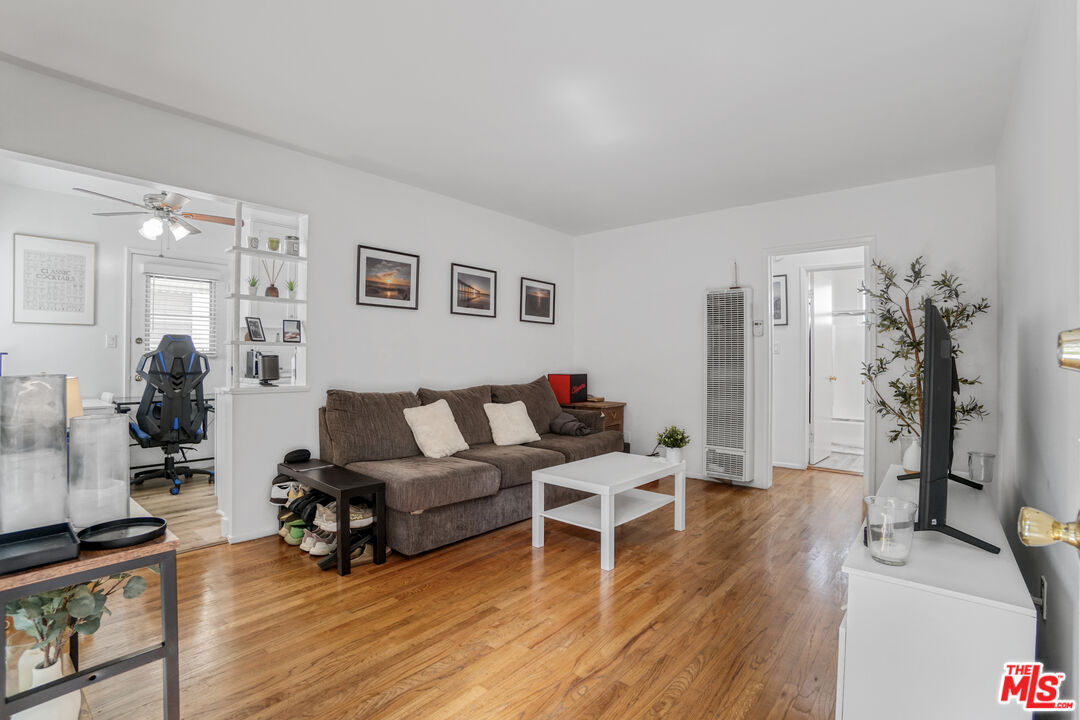 1246 South Saltair Avenue Los Angeles, CA 90025 - Photo 12 of 27 a living room with furniture and a wooden floor