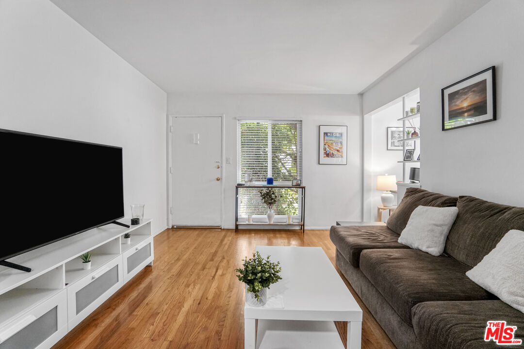 1246 South Saltair Avenue Los Angeles, CA 90025 - Photo 13 of 27 a living room with furniture and a flat screen tv