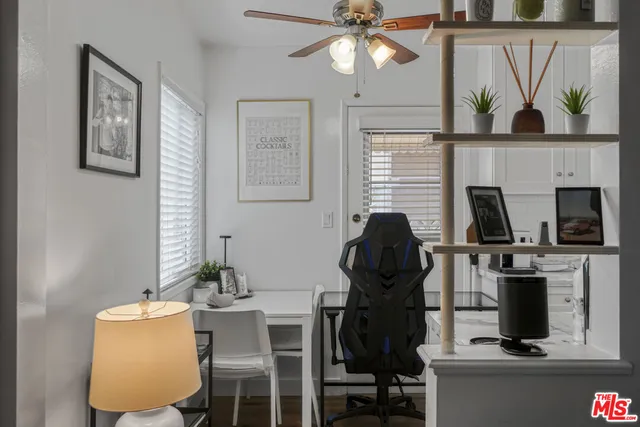 a view of a workspace with furniture and a fireplace