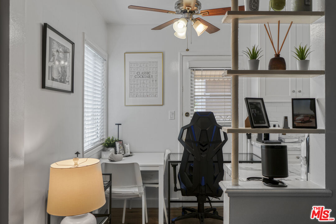 1246 South Saltair Avenue Los Angeles, CA 90025 - Photo 14 of 27 a view of a workspace with furniture and a fireplace