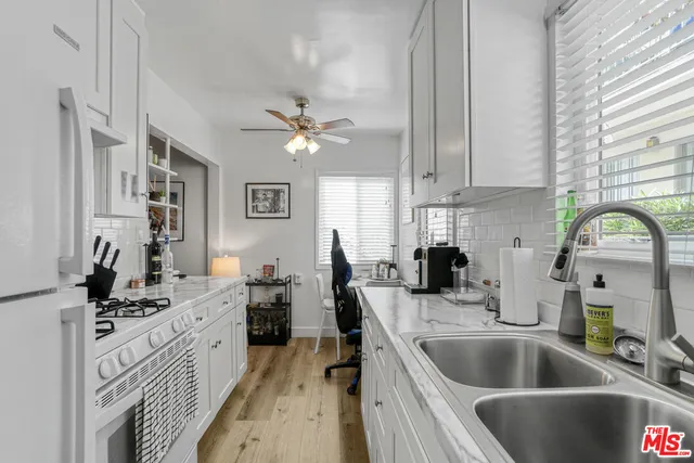 a kitchen with a sink cabinets and window