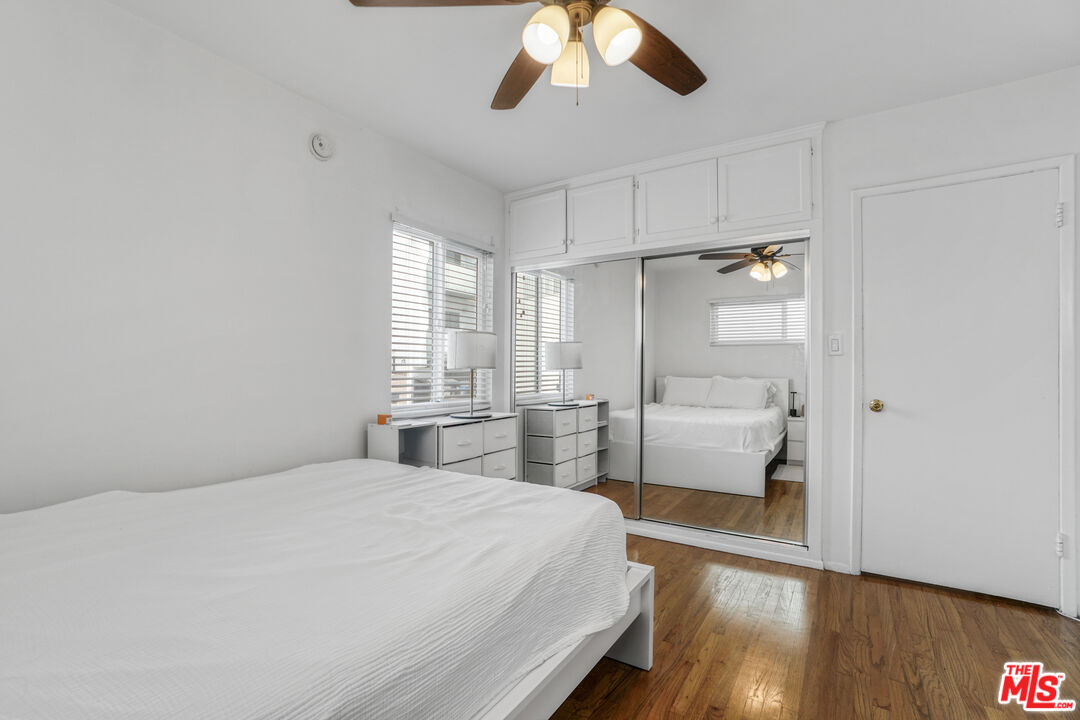 1246 South Saltair Avenue Los Angeles, CA 90025 - Photo 19 of 27 a bedroom with a large bed and a chandelier