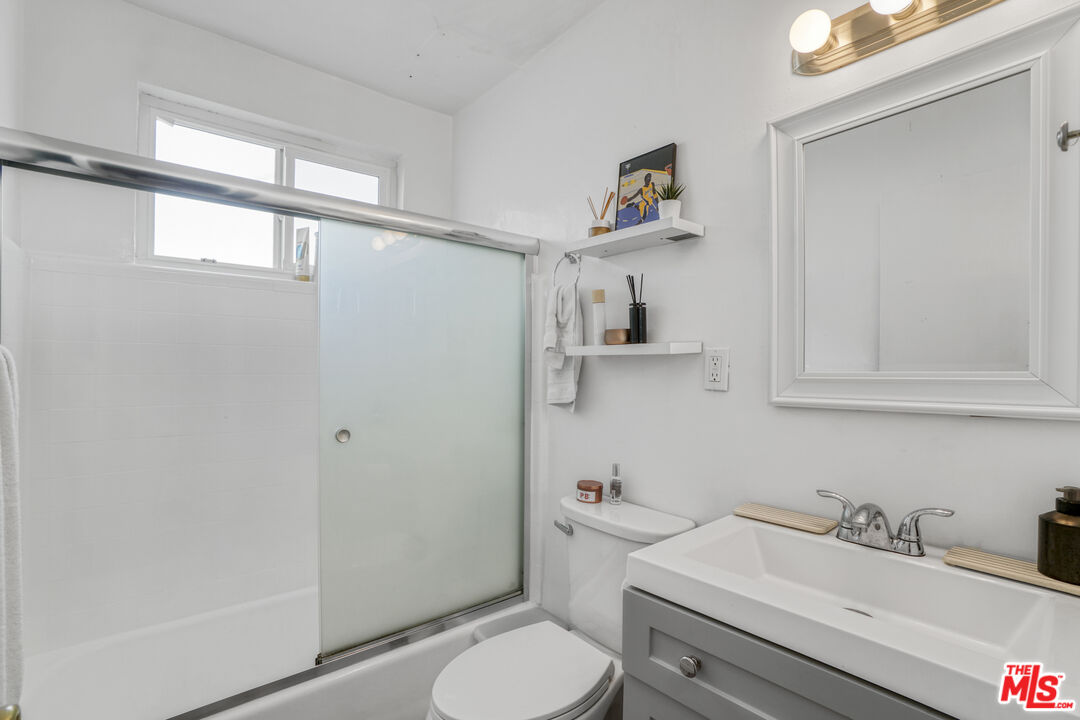 1246 South Saltair Avenue Los Angeles, CA 90025 - Photo 20 of 27 a bathroom with a sink toilet and window