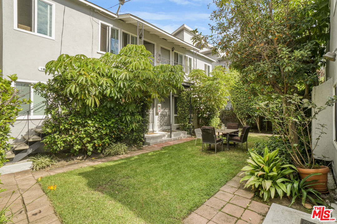 1246 South Saltair Avenue Los Angeles, CA 90025 - Photo 4 of 27 a view of a chair and table in backyard of the house