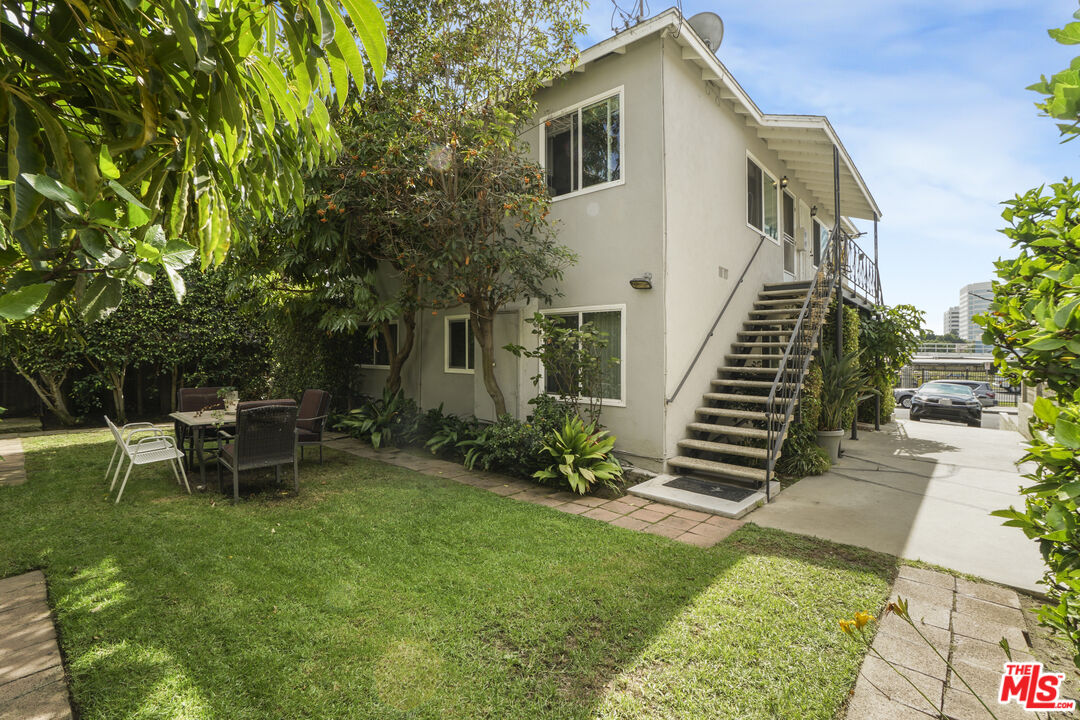 1246 South Saltair Avenue Los Angeles, CA 90025 - Photo 6 of 27 a backyard of a house with table and chairs