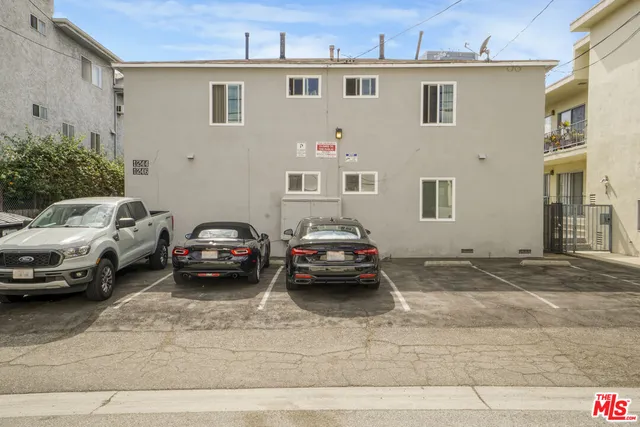 a view of a cars park in front of a building