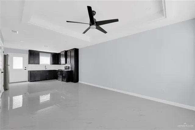 a view of kitchen with refrigerator and window