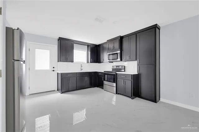 a kitchen with stainless steel appliances a refrigerator and a sink
