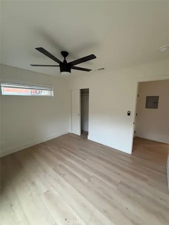 en empty room with windows and ceiling fan