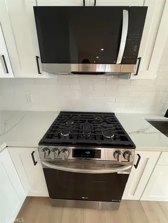 a close view of a sink in a white cabinet