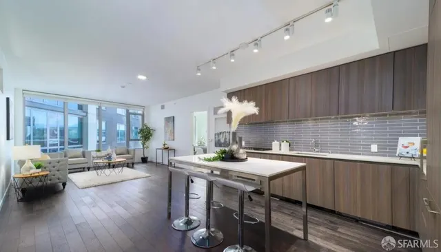 a kitchen with a sink a counter and chairs