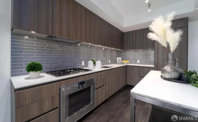 a kitchen with a sink stove and cabinets