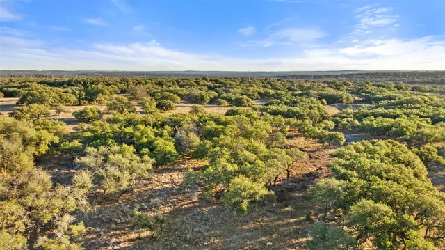 an aerial view of residential building with green space