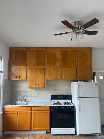a kitchen with a stove a sink and a refrigerator