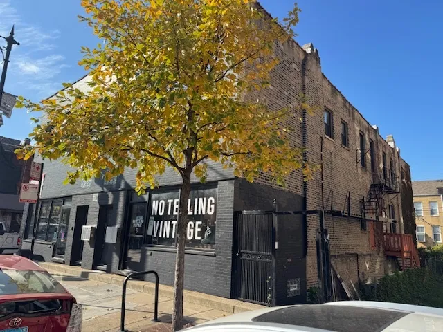 a view of a brick building next to a road