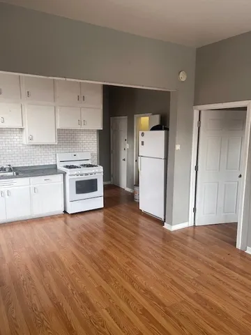 a view of a kitchen with a sink and a refrigerator