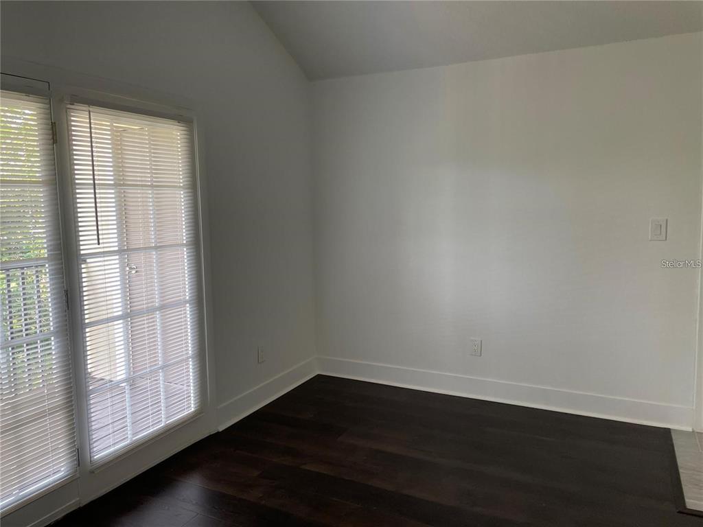 199 Afton Square, Unit 309 Altamonte Springs, FL 32714 - Photo 11 of 17 an empty room with wooden floor and windows