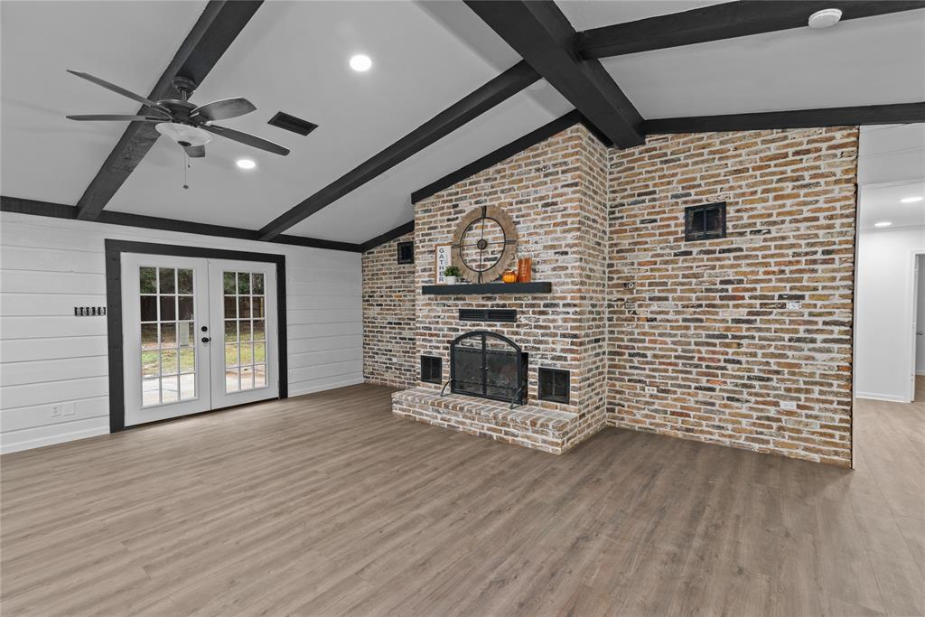 a view of a livingroom with a fireplace and wooden floor