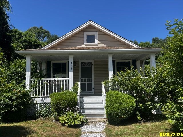 703 Mill Street Marion, MA 02738 - Photo 1 of 16 a front view of a house with a yard
