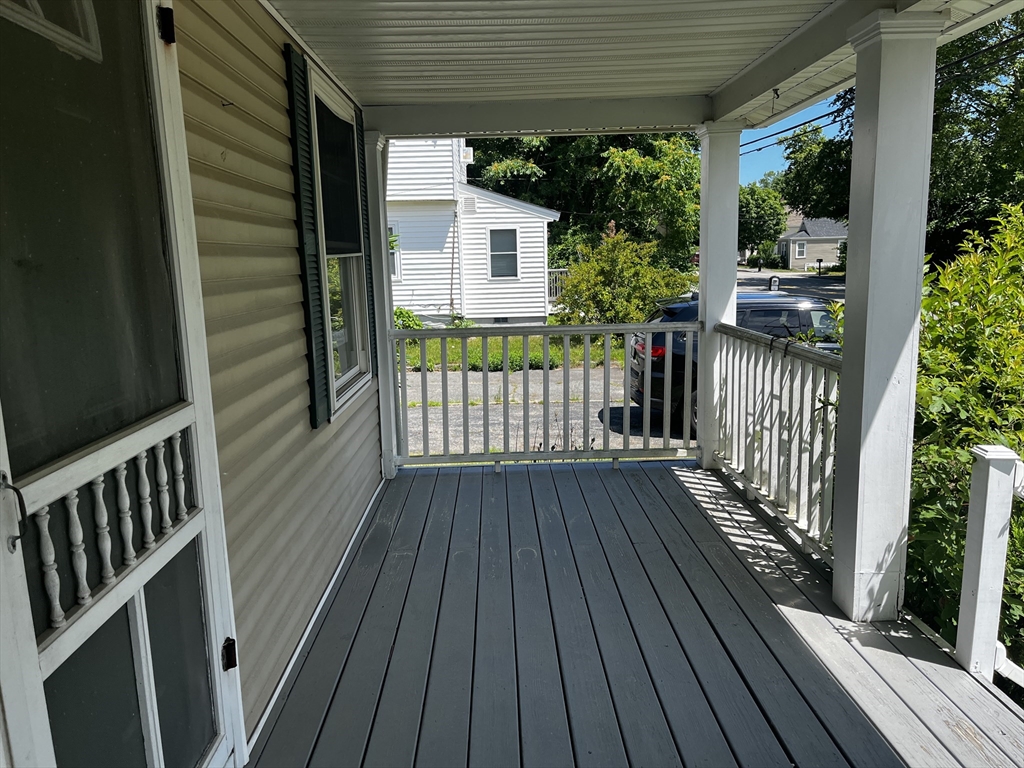 703 Mill Street Marion, MA 02738 - Photo 5 of 16 a view of deck with wooden floor and fence