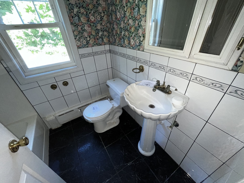 703 Mill Street Marion, MA 02738 - Photo 10 of 16 a bathroom with a sink toilet and a mirror