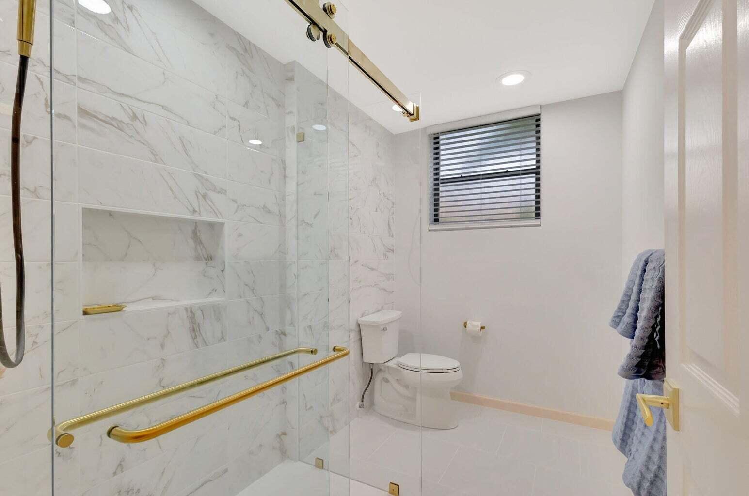 16151 West Bay Drive, Unit 161 Jupiter, FL 33477 - Photo 17 of 25 a bathroom with a toilet and a shower