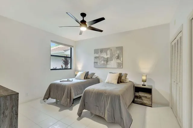 a bedroom with two beds and a painting